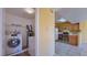 Laundry room with washer, dryer, shelving, and open to the kitchen area at 2020 Rancho Lake Drive Dr # 205, Las Vegas, NV 89108