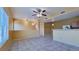 Bright living room with tile flooring, ceiling fan, and a view of the kitchen at 2020 Rancho Lake Drive Dr # 205, Las Vegas, NV 89108
