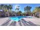 Community pool and hot tub surrounded by trees and wrought iron fence at 2020 Rancho Lake Drive Dr # 205, Las Vegas, NV 89108
