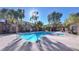 Community pool with hot tub surrounded by lush landscaping and fencing at 2020 Rancho Lake Drive Dr # 205, Las Vegas, NV 89108