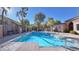 Community pool surrounded by a fence and lush greenery on a sunny day at 2020 Rancho Lake Drive Dr # 205, Las Vegas, NV 89108