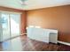 Bedroom with wood floors, balcony access, and ceiling fan at 3719 Colonial Dr, Las Vegas, NV 89121