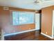 Bedroom with wood floors, large window, and door at 3719 Colonial Dr, Las Vegas, NV 89121