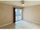 Bedroom with tile floors, sliding door to patio, and ceiling fan at 3719 Colonial Dr, Las Vegas, NV 89121