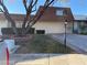 Front view of a tan house with a brown roof and a large tree at 3719 Colonial Dr, Las Vegas, NV 89121