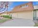 Tan colored exterior, attached garage, and manicured landscaping at 3719 Colonial Dr, Las Vegas, NV 89121