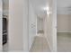 Long hallway with neutral walls and tiled floors at 3719 Colonial Dr, Las Vegas, NV 89121