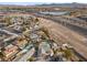 Aerial view showcasing a house with a pool in a residential area near a highway at 4767 Del Sueno Dr, Las Vegas, NV 89120