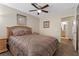 Bedroom with queen bed, ceiling fan, and access to bathroom at 4767 Del Sueno Dr, Las Vegas, NV 89120