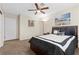 Bright bedroom with a ceiling fan, carpet flooring, and a double bed at 4767 Del Sueno Dr, Las Vegas, NV 89120