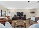 Living room with large TV, leather sofas, and ceiling fan at 4767 Del Sueno Dr, Las Vegas, NV 89120