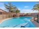 Sparkling kidney shaped pool with safety fence at 4767 Del Sueno Dr, Las Vegas, NV 89120