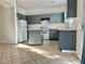 Galley kitchen with island, gray cabinets, and tile floor at 5455 Hasley Canyon Ave, Las Vegas, NV 89139