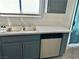 Gray kitchen cabinets with stainless steel dishwasher at 5455 Hasley Canyon Ave, Las Vegas, NV 89139