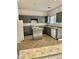 Galley kitchen with island, gray cabinets, and tile floor at 5455 Hasley Canyon Ave, Las Vegas, NV 89139