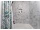 Shower with hexagon marble-look tile at 664 Spring Rd, Indian Springs, NV 89018