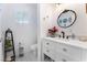 Charming bathroom with white vanity, marble floors, and decorative mirror at 664 Spring Rd, Indian Springs, NV 89018