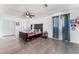 Main bedroom with wood floors, ceiling fan, and large window at 664 Spring Rd, Indian Springs, NV 89018