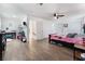 Main bedroom with a bed, ceiling fan, and wood floors at 664 Spring Rd, Indian Springs, NV 89018