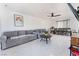 Spacious living room featuring gray sofas, a coffee table, and dining area at 664 Spring Rd, Indian Springs, NV 89018