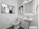 Stylish powder room with pedestal sink and modern fixtures at 9637 Lions Peak Ct, Las Vegas, NV 89139