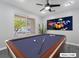 Game room features a pool table and window overlooking the backyard at 9637 Lions Peak Ct, Las Vegas, NV 89139