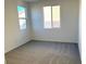 Simple bedroom with gray carpet and windows at 9922 Angel Valley Dr, Las Vegas, NV 89178