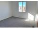 Bright bedroom with gray carpet and window at 9922 Angel Valley Dr, Las Vegas, NV 89178