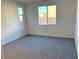 Well-lit bedroom with grey carpet and large window offering natural light at 9922 Angel Valley Dr, Las Vegas, NV 89178