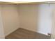 Spacious walk-in closet with wood shelving and grey carpeting at 9922 Angel Valley Dr, Las Vegas, NV 89178