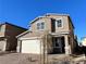 Two-story house with neutral exterior, attached garage, and landscaped front yard at 9922 Angel Valley Dr, Las Vegas, NV 89178