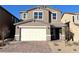 Two-story house with neutral exterior, attached garage, and landscaped front yard at 9922 Angel Valley Dr, Las Vegas, NV 89178