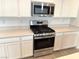 Stainless steel range, microwave, and oven in a modern kitchen setting at 9922 Angel Valley Dr, Las Vegas, NV 89178