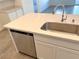 Kitchen island with stainless steel sink, dishwasher, and quartz countertop at 9922 Angel Valley Dr, Las Vegas, NV 89178