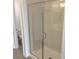 Walk-in shower with frameless glass enclosure and tiled surround at 9922 Angel Valley Dr, Las Vegas, NV 89178