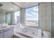 Bathroom with tub, vanity, and shower; natural light at 222 Karen Ave # 3907, Las Vegas, NV 89109
