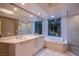This bathroom features dual sinks, bathtub, and shower with a city view at 222 Karen Ave # 3907, Las Vegas, NV 89109