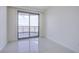 Bright bedroom features modern tile flooring and a sliding glass door opening to a balcony at 222 Karen Ave # 3907, Las Vegas, NV 89109