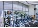 On-site gym with elliptical machines, bikes and weights in front of large windows at 222 Karen Ave # 3907, Las Vegas, NV 89109