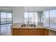 Modern kitchen with a double sink and amazing views of the city skyline out the window at 222 Karen Ave # 3907, Las Vegas, NV 89109