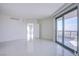 Bright, airy living room with sleek tile flooring and a wall of windows leading to the balcony at 222 Karen Ave # 3907, Las Vegas, NV 89109