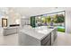 Modern kitchen island with stainless steel appliances and pool view at 2293 Buckingham Ct, Henderson, NV 89074