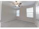 Bedroom with plush carpet, neutral walls, ceiling fan and two windows providing ample natural light at 3026 Coveri Ct, Las Vegas, NV 89141