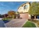 Two-story home with a brick driveway, manicured lawn, and a two-car garage at 3026 Coveri Ct, Las Vegas, NV 89141