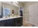 Bathroom featuring double sinks, dark wood cabinets, and tile flooring at 6837 Dragonfly Rock St, Las Vegas, NV 89148