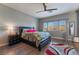 Comfortable main bedroom with wood floors, ceiling fan, and lots of natural light at 6837 Dragonfly Rock St, Las Vegas, NV 89148