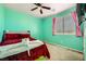 Charming bedroom with mint walls and a queen bed at 10414 White Princess Ave, Las Vegas, NV 89166