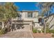 Two-story house with gray siding, stone accents, and a two-car garage at 10414 White Princess Ave, Las Vegas, NV 89166