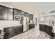 Modern kitchen with dark cabinets, stainless steel appliances, and quartz countertops at 10414 White Princess Ave, Las Vegas, NV 89166