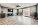 Spacious living room with wood-look floors, sliding glass door, and ceiling fan at 10414 White Princess Ave, Las Vegas, NV 89166